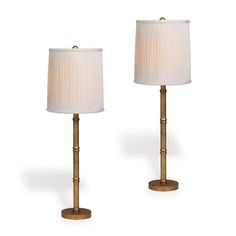 two lamps with white shades on them