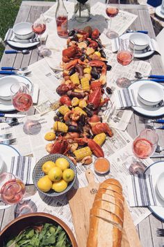 a long table with lobsters and other food on it