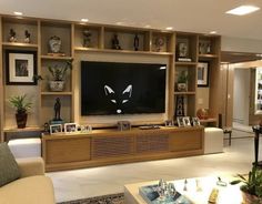 a living room filled with furniture and a flat screen tv