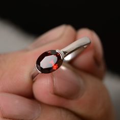 This is a gorgeous handmade creation. Its beauty is its simplicity & Elegance. The 6*8mm oval shape natural garnet (January birthstone) is crafted in solid sterling silver and with rhodium plated. All item is sent in a beautiful gift box You can realize more lovely stuff clicking the link https://www.etsy.com/shop/knightjewelry?refshopsection_shophome_leftnav Please leave the correct address and you phone number for delivering successfully. Blacksmithing Ideas, January Birthstone Rings, Sterling Silver Garnet Ring, Garnet Engagement Ring, Red Garnet Ring, Ruby Rings, Unique Jewelry Gifts, Dungeons Dragons, Sterling Silver Engagement Rings