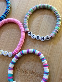 four bracelets with the word ahoh written on them, all in different colors