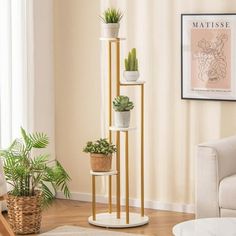 three plant stands in a living room next to a couch