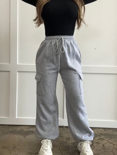 These cargo joggers in gray are perfect for those who like a high-waisted look. They come with an elastic waistband for a comfortable fit, and there's even a drawstring for added style! Enjoy these joggers for a laid-back, casual vibe. DETAILS Gray cargo joggers High waisted fit Elastic waistband with drawstring Comfy, casual fit SIZING INFO Fits true to size Chelsea is wearing size small MEASUREMENTS Size US Bottom Length Waist Waist Stretch Amount Hip S 4 40.6 25.2 38.6 42.5 M 6/8 40.9 26.8 40 Gray Joggers With Elastic Waistband, Trendy Relaxed-fit Joggers With Drawstring, High-waist Cotton Joggers With Drawstring, Cheap Cotton Cargo-style Joggers, Solid Color Full-length Joggers With Drawstring, Cargo Joggers, Casual Fits, Elastic Waist, Light Grey