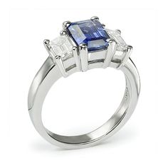 This amazing three stone engagement ring has a spectacular Emerald Cut Blue Sapphire at its center. This gemstone is an emerald step cut sapphire with a 1.54 ct. weight and its signature blue color. It is coupled with a pair of emerald cut diamond side stones both with precisely matched G color and immaculately eye clean VS-1 natural clarity. They are set into this platinum ring we can make in any finger size. Wedding Sapphire Ring With Three Stones In Radiant Cut, Blue Radiant Cut Three-stone Ring, Three Stone Sapphire Ring With Radiant Cut Diamond, Lab-created Sapphire Three Stone Emerald Cut Rings, Emerald Cut Sapphire And Diamond Three Stone Ring, Emerald Cut Sapphire Three Stone Jewelry, Luxury Three Stone Emerald Cut Sapphire Ring, Luxury Three-stone Emerald-cut Sapphire Ring, Emerald Cut Sapphire Ring With Three Stones