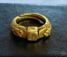 "Offered is a very old and quite rare Chinese 24k double Dragon Ring. Pre 18th century...probably Ming Dynasty. Hand carved with finely detailed double dragons and chinese calligraphy on the ring as well as on the shank. This ring has been in a case for well over 40 years, I have rarely handled it, in order to avoid causing further wear to the dragons and other details. An incredible piece of Chinese history. Weight 7.8g Metal - 24k High Karat Gold (verified) Hallmarks - Chinese Characters insid Double Dragon, Dragon Ring, Chinese History, Chinese Calligraphy, Ming Dynasty, Chinese Characters, Antique Diamond, Pinky Ring, Opal Rings