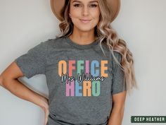 Celebrate the first day of school with your office hero crew wearing these cute and customized name shirts. This brand of shirt is everyone's favorite. It's incredibly soft, lightweight, not boxy, just the right amount of stretch, comfortable yet cute. Your new go-to tee from Bella + Canvas. Professionally printed direct-to-garment printing, which prints the color directly into the shirt to ensure no cracking or peeling like vinyl or screen printing.  Be sure to check out my other designs! https Administrative Professional Day, School Secretary, The Office Shirts, Assistant Gifts, School Office, Classy Chic, School Shirts, Heather Black, Professions