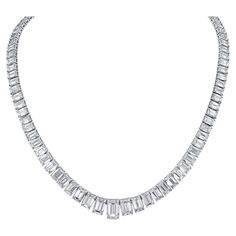 Elevate your elegance with our exquisite 19-inch Graduated Tennis Necklace, meticulously crafted in platinum and adorned with captivating emerald-cut diamonds. Each diamond is expertly set in a secure four-prong setting, showcasing their brilliance and clarity. The focal point of this masterpiece is the GIA certified H/SI2 emerald center, weighing 1.51 carats, radiating with unparalleled beauty and sophistication. With a total diamond weight of 30.04 carats, this necklace is a true statement of luxury and refinement. Indulge in timeless elegance with our Graduated Tennis Necklace, a symbol of enduring beauty and sophistication. Luxury Prong Setting Necklace, Luxury Formal Baguette Cut Tennis Necklace, Tennis Diamond Necklace, Emerald Cut Necklace, Riviera Necklace, Diamond Tennis Necklace, Sparkly Things, Emerald Cut Diamond, Chicago Pd