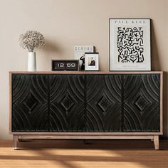 the sideboard is decorated with black and white art on it's sidesplash