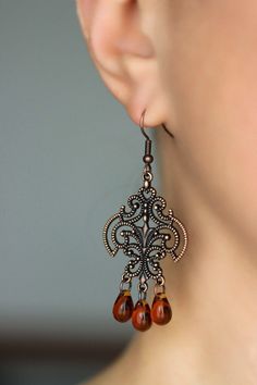 These beautiful boho earrings was made of tea color czech glass drop beads, copper chandelier charms, copper jumping rings and copper earrings hooks. Earrings hooks are from nickel free and lead free metal. Perfec for your unique outfit and a great gift for someone special! *The total lenght of earrings is about 63 mm including earring hooks. Other earrings of my shop you can see here: https://www.etsy.com/shop/NaTavelli?section_id=13757927 Thanks for visit. Brown Czech Glass Teardrop Earrings, Vintage Brown Earrings With Dangling Beads, Vintage Brown Beaded Dangle Earrings, Copper Chandelier Dangle Earrings For Pierced Ears, Brown Czech Glass Beaded Drop Earrings, Bohemian Brown Teardrop Earrings For Gift, Bohemian Brown Teardrop Earrings Gift, Bronze Dangle Chandelier Earrings, Brown Teardrop Czech Glass Jewelry