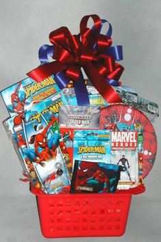 a red basket filled with comic books and magazines, wrapped in a satin ribbon bow