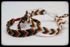 two braided bracelets sitting next to each other on top of a white surface