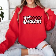 Teacher Sweatshirt, Checkered Teacher Sweater, Retro Teacher Sweatshirt, Gift for Teacher, Back to School Sweater, New Teacher Gift Introducing our sweatshirt, made with a high-quality cotton and polyester blend for ultimate comfort and style. This sweatshirt is perfect for any occasion and can be dressed up or down. The air-jet yarn ensures a softer feel and less pilling, while the absence of side seams adds to its sleek look. Double needle stitching on the shoulders, armhole, neck, waistband, and cuffs provide extra durability for long-lasting wear. Our sweatshirts are made with 8 oz. (US) 13.3 oz. (CA) 50/50 preshrunk cotton/polyester, with 60/40 Heather sport colors being a polyester/cotton blend. They feature a 1x1 rib with spandex and are quarter-turned to eliminate the center crease Teacher Sweater, Retro Crew Neck T-shirt For Teacher Appreciation, School Sweater, New Teacher Gift, Teacher Back To School, New Teacher Gifts, Teacher Sweatshirt, New Teacher, Green Sweatshirt