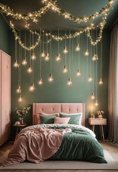 a bedroom with green walls and lots of lights hanging from the ceiling over the bed