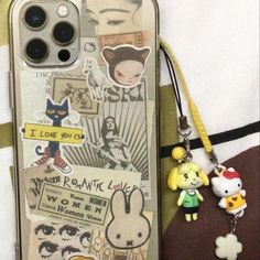 an iphone case with stickers on it and a keychain attached to it