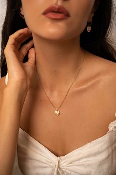 The Lise pearl heart necklace is handcrafted with a heart shaped freshwater pearl and a delicate heart chain. A perfectly classic romantic piece, easy to dress up or down.  14K gold-filled heart chain Heart-shaped freshwater pearl Hypoallergenic, suitable for even the most sensitive skin Each piece is delivered in a silk bag inside a gift box Sustainable packaging   Please note, as we use only natural pearls, shape and size may vary slightly.  We offer a one year guarantee from the date of deliv Elegant 14k Gold Filled Heart Necklace, Gold Pearl Necklace With Heart Charm And Pendant, Delicate Heart Necklace With Delicate Chain, Heart Necklace With Pearl Chain For Gift, Elegant 14k Gold-filled Heart Charm Necklaces, Feminine Heart Charm Necklace For Wedding, Gold Pearl Necklace With Heart Pendant And Beads, Elegant Open Heart Necklace With Heart Beads, Elegant 14k Gold-filled Heart Charm Necklace