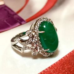 MADE TO ORDER ONLY! 1 week gold crafting period. EXTREMELY VIVID, Certified 7.57 carats, COLOMBIAN Emerald ring. SUGGESTED RETAIL VALUE: $18,000 EMERALD: Weight: 6.63 carats Shape: Oval Cabochon Dimensions: 9.27 x 14.73 x 5.90 mm Color: Green Origin: COLOMBIAN NATURAL EMERALD WITH OIL TREATED ONLY (F3) Gemological certificate provided as shown. TRANSPARENT EXTREMELY CLEAN EXCELLENT COLOR AND CUT! RARE VIVID, COLOMBIAN, BLUISH-GREEN COLOR!! DIAMONDS: 50 round brilliant diamonds weighting a total Luxury Diamond Gemstones With Cabochon Cut, Luxury Diamond Cabochon Gemstones, Luxury Oval Cabochon Diamond Gemstones, Exquisite Platinum Gemstones, Luxury Oval Cabochon Gemstones For Anniversary, Luxury Diamond Cabochons For Wedding, Exquisite Formal Gemstone Cabochons, Formal Hallmarked Diamond Cabochons, Elegant White Gold Cabochons For Formal Occasions