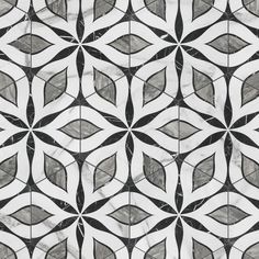 a black and white tile design with leaves