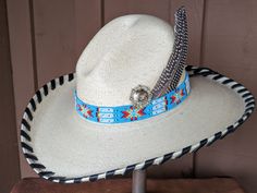 The Renegade Gus Palm Hat has a 4" brim and 5 1/2" crown. Super comfortable with a sweat band on the inside. Hand laced in black leather lace. Beautiful blue beaded hatband is secured on the hat and the back of the band has a deer antler bead. Accented with a Concho and Guinea feathers. Note: Hats are made to order. Please allow up to 4 weeks for your hat to ship Country Style Hat With Flat Crown For Country Events, Adjustable Short Brim Top Hat For Rodeo, Adjustable Straw Hat With Flat Crown For Country Events, Adjustable Country Hat With Flat Crown, Adjustable Country Style Hat With Flat Crown, Adjustable Custom Top Hat For Country Events, Western Adjustable Hats For Kentucky Derby, Adjustable Panama Hat With Flat Crown For Country Events, Adjustable Panama Hat For Country Events