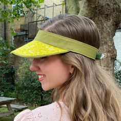 Boo That have reimagined the sun visor into fashionable, luxurious statement headwear. They are lightweight and soft to wear and to handle.  Visors are made one at a time, by hand, in my London millinery studio in a range of carefully curated fabrics.  Size Medium fits approximately 53-59cm head size. Chartreuse yellow graphic print with contrast sage green linen. They were developed originally for a customer who wanted something prettier than a sports visor to protect her skin when she was havi Lightweight Adjustable Fit Hat For Spring, Summer Hats With Uv Protection And Adjustable Fit, Adjustable Curved Brim Hat For Summer, Adjustable Sun Hat With Upf 50+ For Spring, Adjustable Fit Sun Hat With Upf 50+ For Spring, Adjustable Lightweight Sun Hat For Spring, Brimmed Summer Outdoor Visor, Adjustable Sun Hat With Uv Protection, Summer Outdoor Brimmed Visor