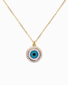 Sparkling round brilliant cut cubic zirconias frame this round medallion lucky evil eye pendant, giving it a touch of modernity as it wards off bad vibes. Rich enamel detail brings this talisman to life in chic style, perfect for adding color and cultural influence to your necklace layering looks. A secure clasp keeps our delicate cable chain Tara Necklace in place, connected to the pendant, keeping it centered. Designed in 925 sterling silver yellow gold plating. Metal Type: 925 Sterling Silver Bad Vibes, Necklace Layering, Eye Pendant, Evil Eye Pendant, Cable Chain, Gold Plating, Round Brilliant, Evil Eye, Types Of Metal