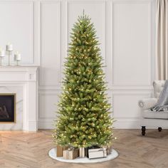 a christmas tree with presents under it in a living room