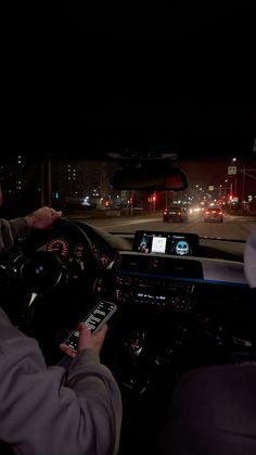 two people are driving in the dark at night