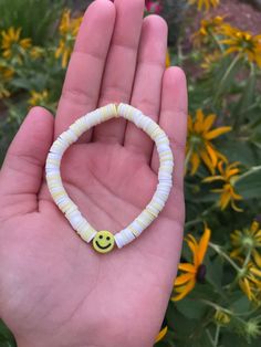 White and yellow clay bead bracelet. Made with clear elastic string that fits most teen writs. Summer White Hand-strung Friendship Bracelets, Adjustable White Stretch Bracelet For Summer, Adjustable Yellow Hypoallergenic Bracelets, Casual Yellow Friendship Bracelets, Yellow Heishi Beads Stretch Bracelet, White Plastic Bracelets As Gifts, Yellow Heishi Beaded Stretch Bracelet, White Plastic Bracelets With Letter Beads, Summer White Heishi Beads Friendship Bracelets