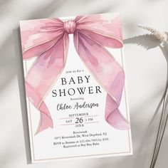 a baby shower is shown with pink ribbon on the front and back of it's card