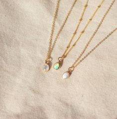 Our Dainty gemstone necklace features a tiny little stone, choose between opal, moonstone and turquoise. DETAILSGOLD VERSION:•PENDANT is Genuine Turquoise, Genuine Moonstone, or Synthetic Opal, measuring 5 x 7mm•CHAIN is 14k Gold Filled•CLASP is 14k Gold Filled Matching ………………………………….PERSONALIZE IT! ADD A STAR INITIAL CHARM:https://www.etsy.com/ca/listing/627638174/add-a-star-initial-charmADD A STAMPED INITIAL:https://www.etsy.com/ca/listing/561708083/add-an-initialADD A BIRTHSTONE:https://www.e Delicate Moonstone Necklace With Delicate Chain, Dainty Adjustable Moonstone Necklace, Delicate Moonstone Round Pendant Necklace, Delicate Round Moonstone Pendant Necklace, Dainty White Necklace With Moon Charm, Delicate Opal Jewelry With Birthstone, Delicate Opal Birthstone Jewelry, Minimalist Everyday Opal Jewelry, Dainty Moonstone Charm Necklace For Gift