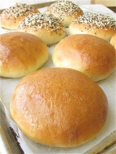 rolls with sesame sprinkles are on a baking sheet