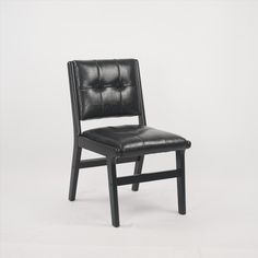 a black leather dining chair against a white background with the seat upholstered to the side