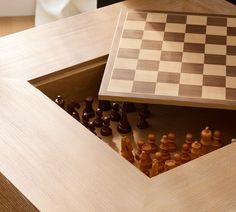 a chess board and pieces in a wooden box