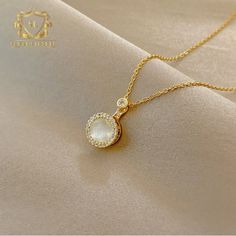 Introducing the epitome of timeless elegance, behold the Gold Necklace with a Pearl Pendant, adorned with a shimmering halo of zirconia stones. This exquisite piece marries the classic allure of pearls with the luxurious charm of gold, creating a mesmerizing fusion of sophistication and grace. At the heart of the necklace, a luminous pearl pendant takes center stage, exuding a timeless beauty that is both understated and captivating. The creamy luster of the pearl radiates with an ethereal glow, evoking a sense of purity and refinement. Surrounding the pearl, a delicate halo of zirconia stones adds a touch of sparkle and brilliance to the necklace, creating a dazzling frame that accentuates the beauty of the central gem. Each stone is meticulously cut and set to perfection, capturing the l Elegant Pearl White Bridal Necklace With Clavicle Chain, Elegant Rose Gold Diamond Bridal Necklace, Elegant Bridal Necklace With Pearl Drop And Cubic Zirconia, White Cubic Zirconia Necklaces With Halo Setting, Timeless Gold Pearl Necklace With Diamonds, Elegant Crystal Bridal Necklace With Clavicle Chain, White Cubic Zirconia Necklace With Halo Setting, Elegant Bridal Crystal Necklace With Clavicle Chain, Elegant White Cubic Zirconia Bridal Necklace