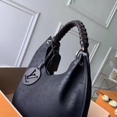 The Carmel hobo bag is a spacious, lightweight style in Mahina calf leather with Monogram perforations. The supple leather and the soft form of the bag combine to make it exceptionally pleasant to carry. Craft details such as the braided handle and LV leather charm add to the sophistication of this model. Detailed Features 35 x 40 x 17 cm (Length x height x width ) Black Mahina perforated calf leather Calf-leather trim Microfiber lining Silver-color hardware Magnetic closure 2 compartments Pocke Sac Louis Vuitton, Black Louis Vuitton, Black Leather Bags, Virgil Abloh, Vuitton Bag, Bags Designer Fashion, Black Bag, Vuitton Handbags, Louis Vuitton Handbags