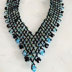 Artisan Czech Glass Bead 20" Long Fashion Statement "V" Style Necklace Turquoise, Black Glass Beads Necklace With Shimmering & Iridescent Beads Easy To Open/Close Magnetic Clasp One Of A Kind Necklace Handcrafted/No Two Are Exactly Alike Would Be Perfect For A Get-A-Way Destination Dress! Necklace Is Made In Guatemala Using Artisan Crafted Czech Glass Beads. Czech Glass Beads Are Know World Wide For Their Quality, Vibrant Colors Principles Of Fair Trade Upheld Black Beaded Necklaces With Bead Caps As Gift, Black Crystal Necklaces With Colorful Beads For Jewelry Making, Bohemian Black Beaded Necklaces With Bead Caps, Bohemian Black Necklaces With Bead Caps, Turquoise Beaded Necklaces With Black Beads As Gift, Turquoise Beaded Necklaces With Black Beads For Festival, Black Bohemian Necklaces With Bead Caps, Unique Black Beaded Necklaces, Unique Black Beaded Necklace