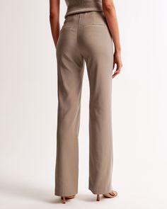 High rise pants, that are fitted at the waist and hips, slightly relaxed at the thigh and eases at the knee into a full-length boot leg shape, in our matte sculpt fabric, featuring a clean front waistband and a fly closure for a secure fit. Seamless Beige High-cut Leg Bottoms, Khaki Fitted Full-length Bottoms, Fitted Ankle-length Khaki Bottoms, Stretch Mid-rise Brown Pants, Non-stretch Brown Cotton Jeans, Women's Bottoms, High Rise Pants, Abercrombie Fitch, Trousers Women