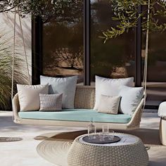 an outdoor seating area with white wicker furniture