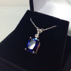 "Beautiful Blue & White Sapphire Pendant Necklace * 4ct Emerald Cut Blue Sapphire measures 10mm x 8mm * Brilliant Cut White Sapphire Accent measures 2.5mm * 4.1cts total gemstone weight * 14k White or Yellow Gold * 18\" Sterling Silver link Chain Included Hallmarked & Gift Ready! Matching Earrings & Ring Also Available! This 4ct Sapphire is Laboratory Grown & is identical to natural in every way, including Chemistry, Composition & Hardness with Excellent Clarity & Color R Blue Sapphire Pendant For Men, Formal Sapphire Necklace With Rectangular Shape, Elegant Sapphire Necklace With Emerald Cut, Timeless Sapphire Jewelry With Prong Setting, Dazzling Sapphire Gemstones For Gift, Dazzling Sapphire Gemstones As Gift, Rectangular Sapphire Jewelry With Accent Stones, Rectangular White Gold Sapphire Jewelry, Radiant Cut Tanzanite Jewelry With Prong Setting