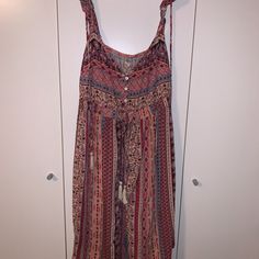 This Dress Is A Size Medium From Hollister And The Straps Are Adjustable Spaghetti Straps As Well As Straps That Go Over The Shoulder And It Has Some Waviness To The Sleeve. On The Top Front, There Are Buttons That Go Down Where The Chest Is So They Can Be Adjusted. There Are Colors Such As Blue, Pink, Burgundy, Beige, And Many More Colors That Are Designed In A Variety Of Patterns Including Some Tribal Patterns. There Is Also A Big Tie That Has Fringes At The End And It Ties In The Back. Nwt. Pink Sleeveless Maxi Dress Beach Cover-up, Pink V-neck Boho Sundress, Pink Casual Boho Beach Dress, Casual Pink Boho Beach Dress, Pink Casual Boho Dress For The Beach, Pink Casual Boho Dress For Beach, Casual Pink Boho Dress For Vacation, Bohemian Multicolor Midi Dress With Spaghetti Straps, Pink Boho Print Summer Dress