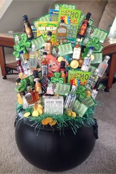 a large black pot filled with lots of liquor and other items sitting on top of a carpeted floor