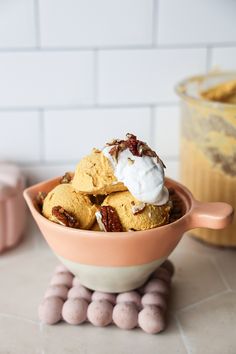 a bowl filled with ice cream and nuts