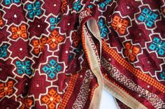 Phulkari refers to the folk embroidery of the Punjab. Although phulkari means floral work, the design include not only flowers but also covers motifs and geometrical shapes. The craft of phulkari has undergone changes over the centuries. This gorgeous colorful phulkari on pure chinnon in burgundy base color is so versatile and can be worn as a dupata, scarf or on any wedding occasion. Our phulkaris are handcrafted to perfection keeping in mind the authenticity of the culture in an urban way. Sta Multicolor Fabric With Resham Embroidery For Festive Occasions, Festive Bohemian Kurta With Woven Motifs, Multicolor Banarasi Silk Fabric With Zari Work For Navratri, Multicolor Resham Embroidery Fabric For Festive Occasions, Festive Multicolor Fabric With Resham Embroidery, Festive Multicolor Resham Embroidery Fabric, Festive Brown Dupatta With Motifs, Embroidered Traditional Wear For Eid Rituals, Embroidered Dupatta For Eid Rituals