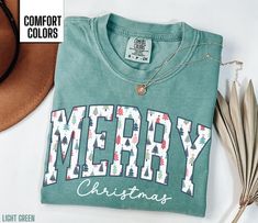 You will love this Merry Christmas shirt for women.  It says Merry in a beautiful Christmas tree font along with Christmas in a script font. This will be the perfect shirt for any woman to wear this holiday season.  Share your Christmas cheer with others this winter. Find our long sleeve tee and crewneck sweatshirts here: Short Sleeve Tee: https://etsy.me/4dGGUaR Long Sleeve Tee: https://etsy.me/3U0W2sW Crewneck Sweatshirt: https://etsy.me/4dxXqKl Comfort Colors T shirt Details: 100% ring-spun c Christmas Shirt For Women, Christmas Green T-shirt With Letter Print, Green Christmas T-shirt With Letter Print, Holiday Green T-shirt With Letter Print, Winter T Shirt, Homemade Shirts, Christmas Shirts For Women, Diy Shirts, Winter T Shirts