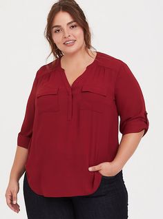 Made from a crisp and fluid fabric, the Harper lends graceful movement to a polished look that's boardroom to brunch approved. Georgette fabric. Split neck. Concealed button placket. 3/4 roll-tab sleeves. Chest pockets. Shirttail hem. CONTENT + CARE: Polyester. Wash cold; dry low. Imported plus size tops. SIZE + FIT: Model is 5'8”, size 1. Size 2 measure 30” from shoulder. The best plus size women's harper georgette pullover 3/4 sleeve blouse the in biking red made of georgette. These dressy clo Workwear Blouse With Rolled 3/4 Sleeves, Red 3/4 Sleeve Tops For Work, Red Chucks, Georgette Blouse, Highlights Brown Hair, Career Wear, Georgette Fabric, Tunic Shirt, Plus Size Blouses