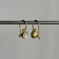 Moonstones with a milky white glow create a darling pair of earrings with handmade clasps. 18k yellow gold Moonstones, 1.81ctw, 6mm (1/4") in diameter Earrings hang 5/8" from the ear Each earring weighs 1.1g Cabochon Earrings, Newport Ri, White Moonstone, Milky White, Gift Card Shop, Moon Stone, Bracelet Gift, Ring Necklace, Newport