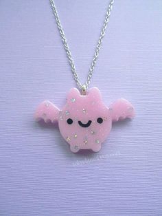 ☆Pastel Pink Kawaii Bat Necklace☆ ☆Bat is made of resin and glitter ☆Has pink glitter and tiny silver star sequins. ☆Chain measures 20 inches but can be made longer upon request.  ☆If you have any questions please message me! Pink Kawaii Heart-shaped Jewelry, Pink Heart-shaped Kawaii Jewelry, Cute Pink Resin Necklace, Kawaii Handmade Silver Necklaces, Kawaii Silver Handmade Necklaces, Handmade Silver Kawaii Necklaces, Whimsical Pink Jewelry With Cute Design, Handmade Silver Necklaces In Kawaii Style, Cute Pastel Jewelry For Gifts