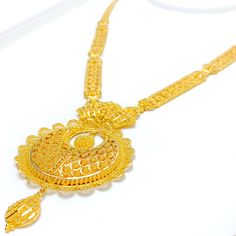 This 22k gold set, weighing a luxurious 60.7 grams, features an extravagant netted floral design that marries sophistication with intricate artistry. The yellow gold finish beautifully highlights the delicate floral motifs, giving the set a lavish and elegant allure. The set's 24-inch length is enhanced by an impressive 3.5-inch drop, and 0.6 inches of adjustable links provide a perfect, customizable fit. A reliable hook lock ensures the necklace stays secure, while the matching 1.5-inch earring Luxury 22k Gold Jewelry For Reception, Luxury 22k Gold Bollywood Necklace, Luxury Long Gold Sets, Hand Set 22k Gold Luxury Necklace, Luxury 22k Gold Hand Set Necklace, Luxury 22k Gold Traditional Jewelry, Intricate Round 22k Gold Jewelry Sets, 22k Gold Jewelry Set With Intricate Design, Diwali Yellow Gold Round Jewelry Sets