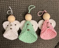 three small crocheted angel ornaments are sitting on the floor next to each other