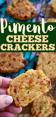 a hand holding up a cheesy cracker that is on top of a cooling rack