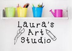 there is a sign that says, laura's art studio on the wall